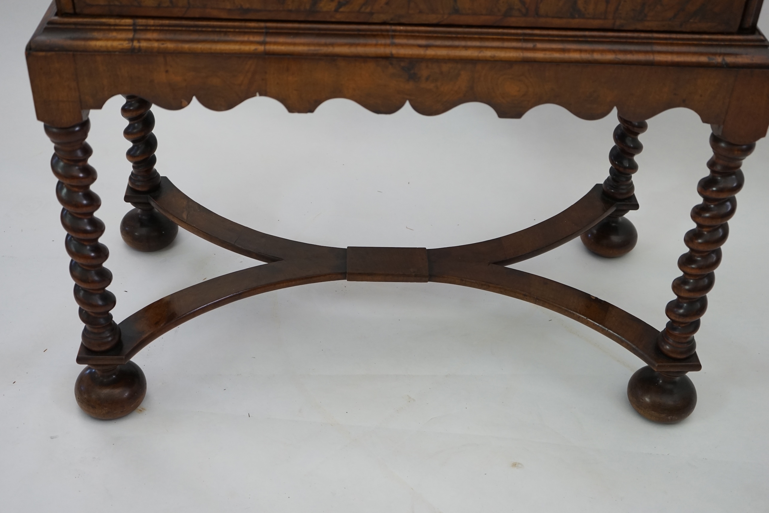 An early 18th century and later crossbanded walnut chest on stand